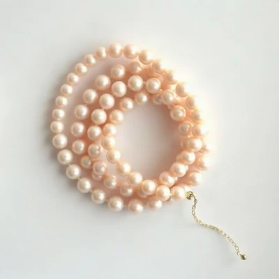 coquette pfp — string of pearls coiled elegantly, blush pink and cream, delicate lace texture